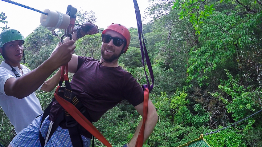 Man stopping on a Zipline in Costa Rica