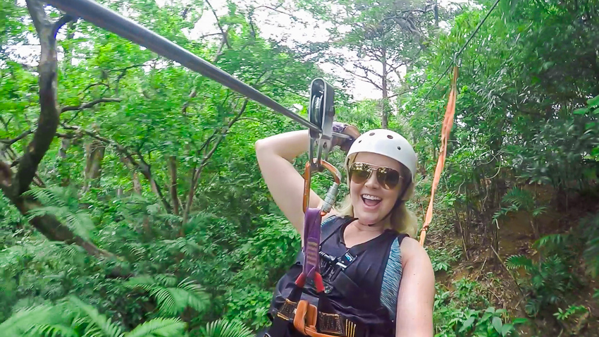 Girl ziplining through rainforest in Costa Rica