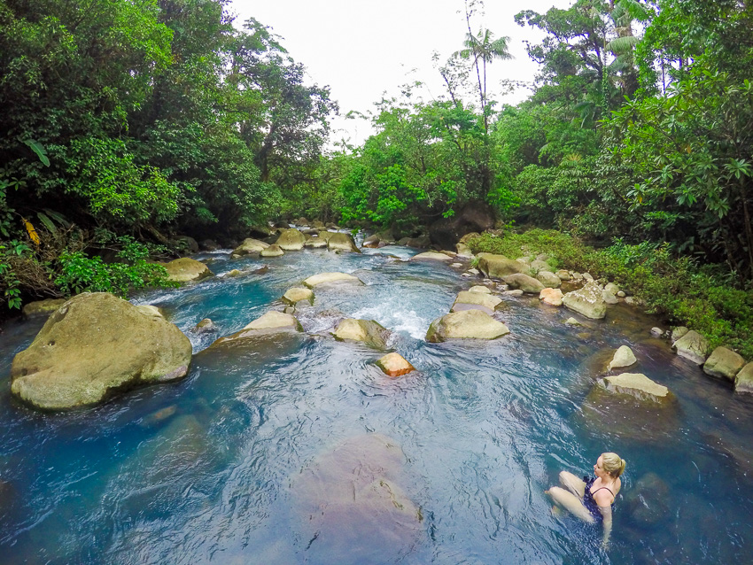 Madison in the bright blue waters of the Rio Celeste River - Hideaway Hotel access