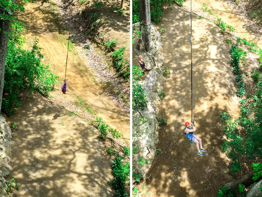 Girl hanging upside down on Tarzan Swing at Congo Canopy in Costa Rica