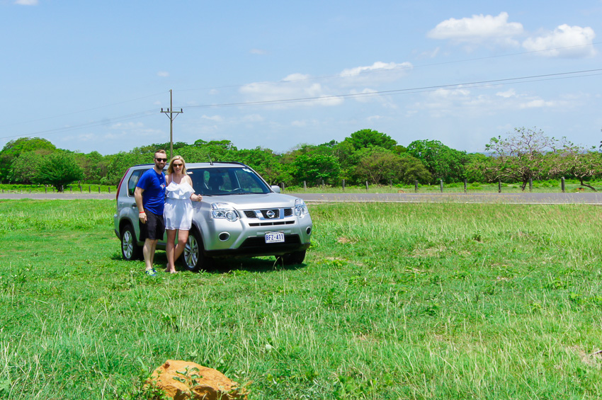 Madison & Liam posing with their car