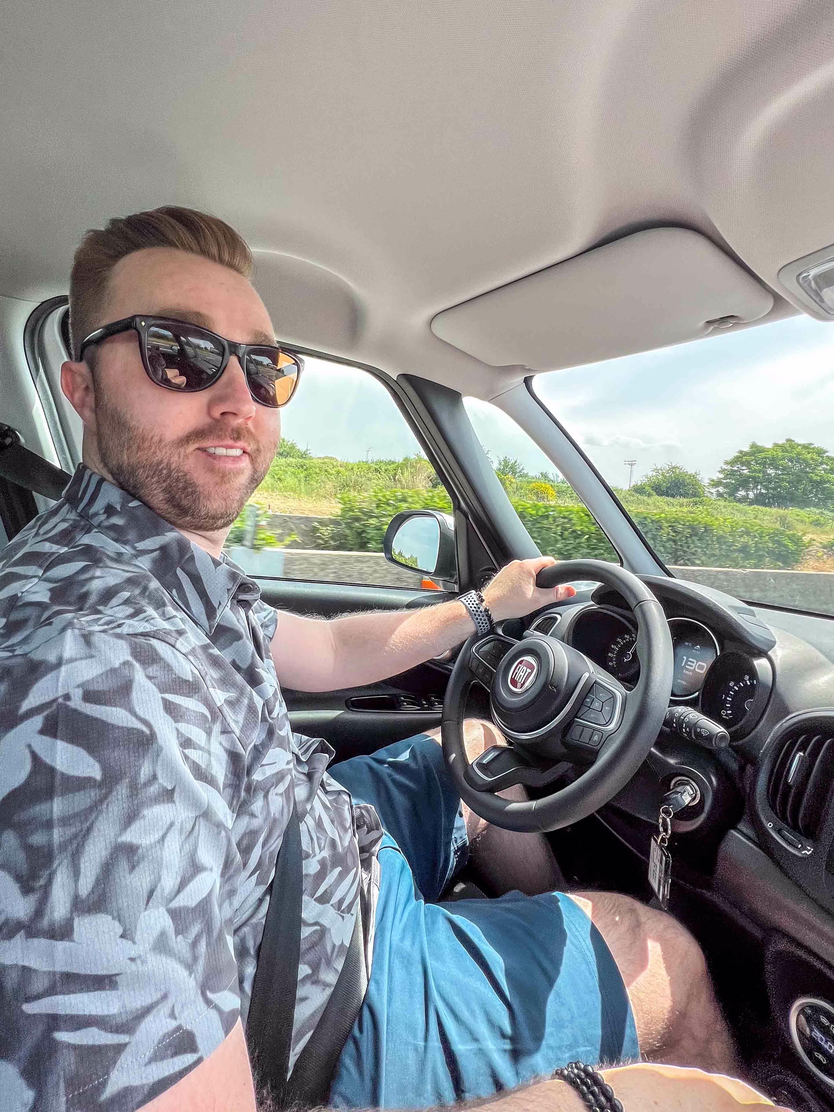 Liam driving a Fiat rental car along the Amalfi Coast in Italy